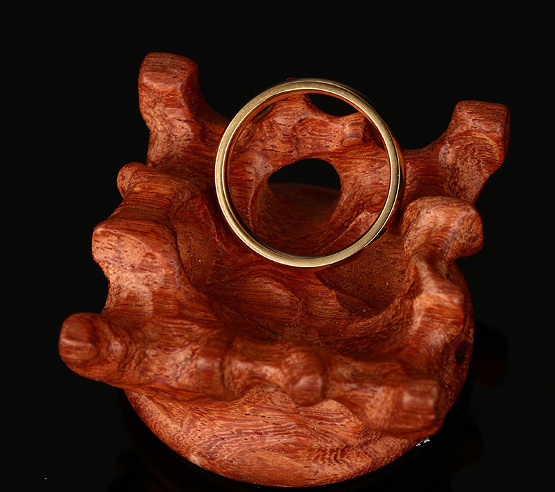 Gold-Tone Domed Stainless Steel Band Ring on black surface view 4