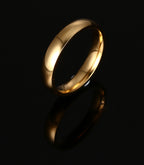 Gold-Tone Domed Stainless Steel Band Ring on black surface view 2
