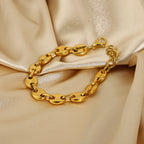 Gold-Tone Coffee Bean Link Bracelet on a light gold fabric background view 3