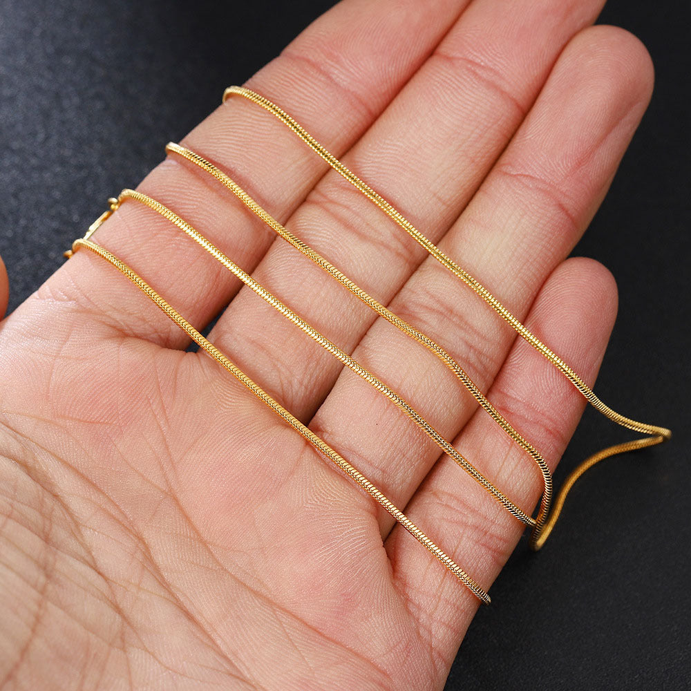 Gold-Tone Stainless Steel Snake Chain on dark background view 3