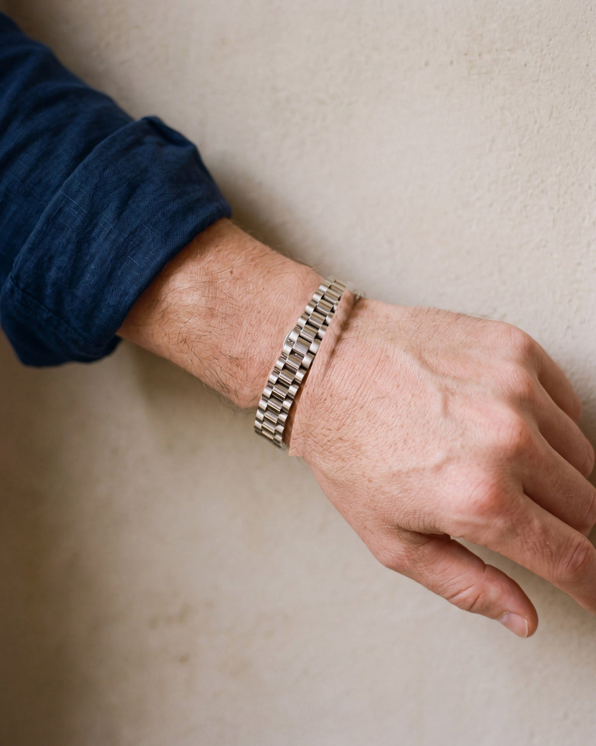 Close-up of the silver-tone Atlas president link bracelet worn, true size