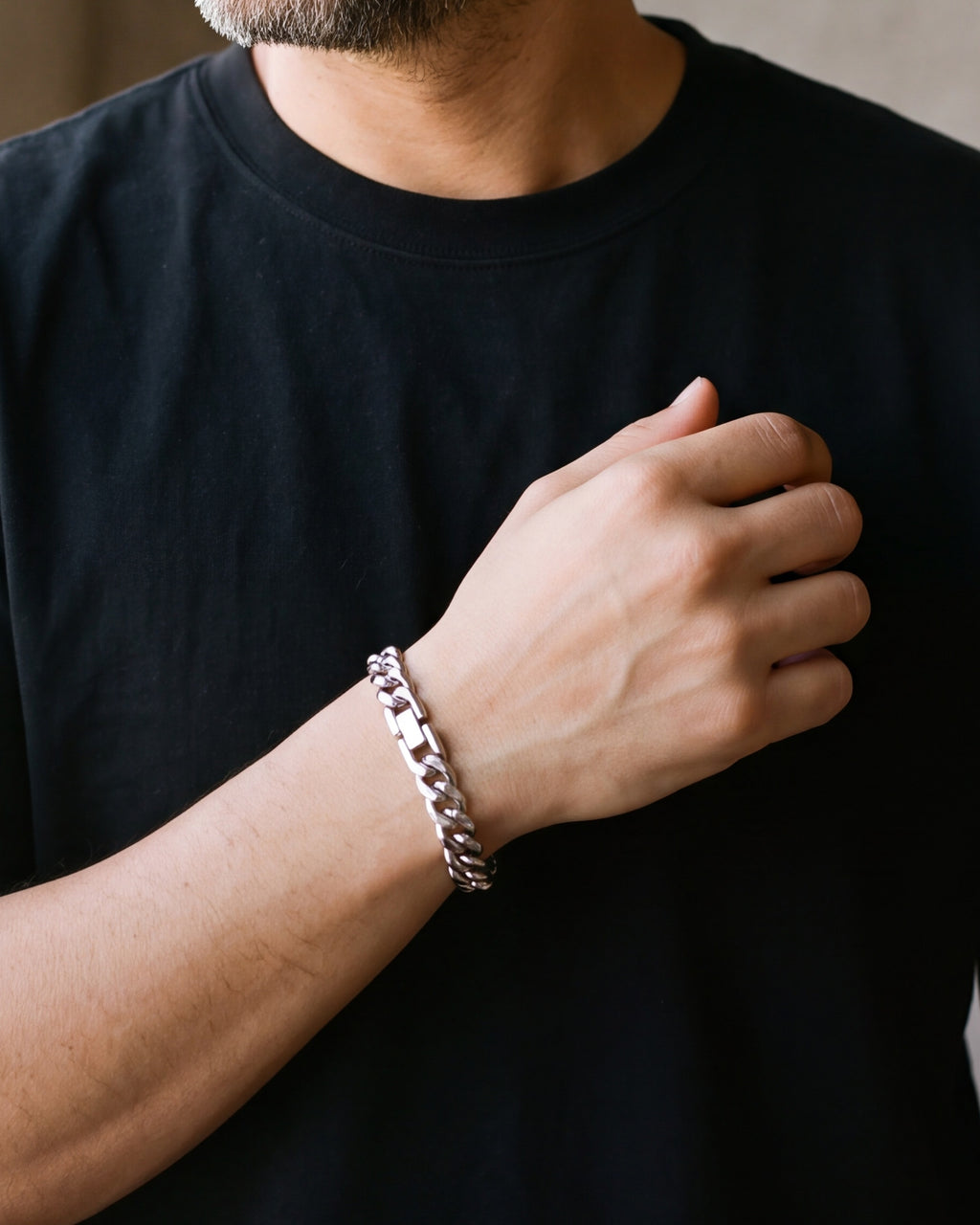 Close-up of the silver-tone Atlas 10 mm Cuban bracelet on a man's wrist
