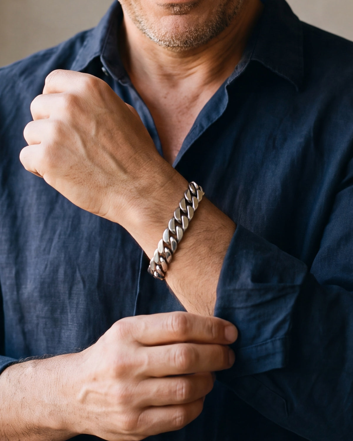 Close-up of the Atlas 10 mm Cuban link bracelet in silver-tone steel, worn at true size