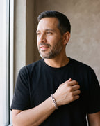 Man in a black T-shirt by a window wearing the silver-tone Atlas 10 mm Cuban link bracelet