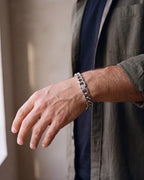 Close-up of the silver Atlas 11mm Silver Cuban Link Bracelet worn by a man, shown at true size
