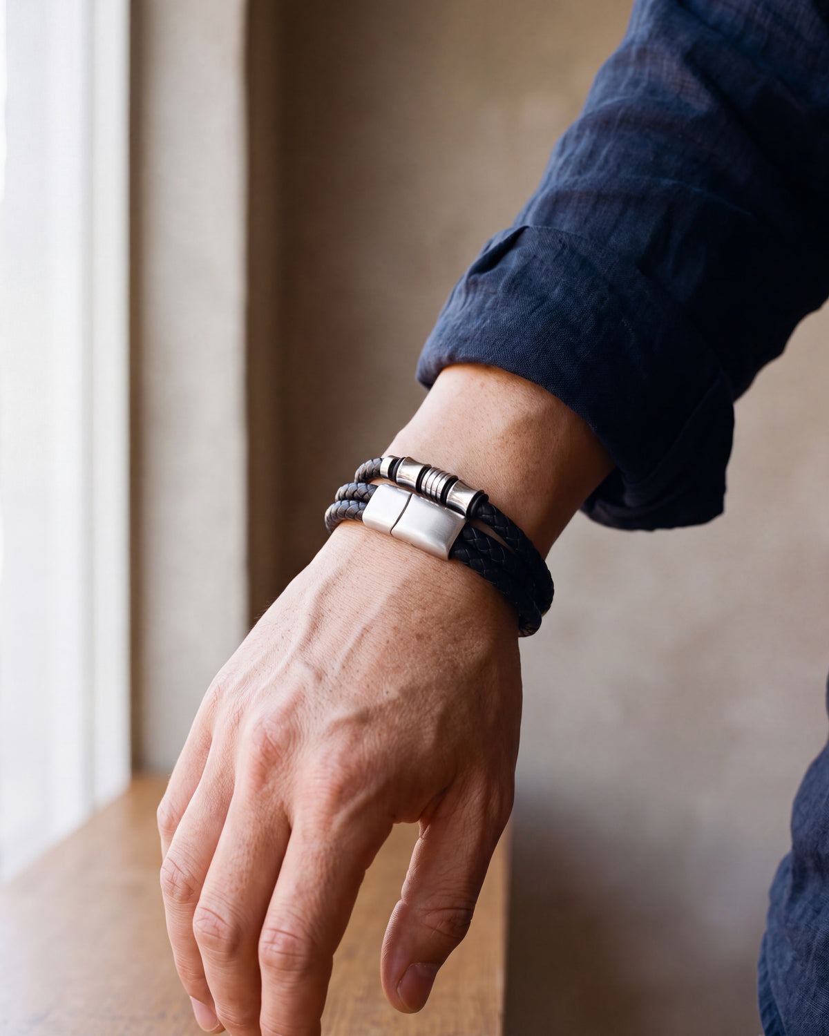 Close-up of the silver-tone Atlas 14mm Braided Leather Bracelet with Magnetic Clasp worn at true size