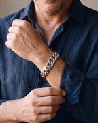 Close-up of the silver Atlas 15mm Titanium Steel Cuban Bracelet worn by a man, shown at true size