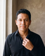 Man in an open-collar black shirt wearing the silver-tone Atlas 2 mm polished band