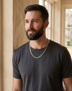 Man by a window wearing the Atlas Miami Cuban Link Chain, 316L Steel