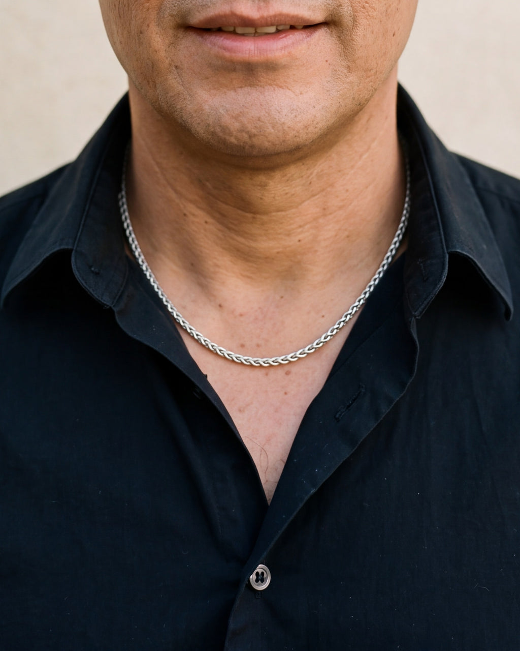 Close-up of the silver Atlas 3 mm wheat chain worn by a man, shown at true size