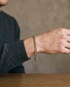 Atlas 5 mm curb link bracelet in silver-tone titanium steel worn on the wrist, close-up