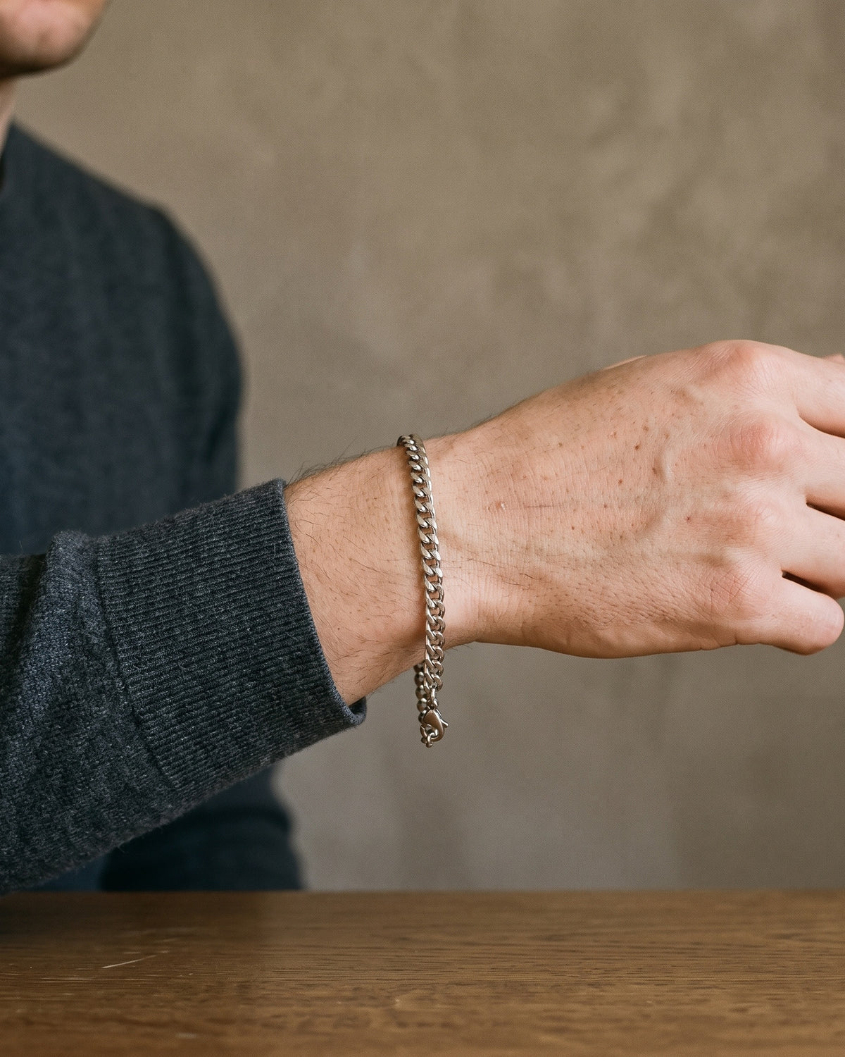 Atlas 5 mm curb link bracelet in silver-tone titanium steel worn on the wrist, close-up