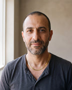 Man in a charcoal henley wearing the Atlas 5 mm flat snake chain in gold-tone steel