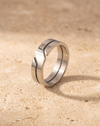 The whole silver-tone Atlas 6 mm geometric cut-out ring laid on warm stone