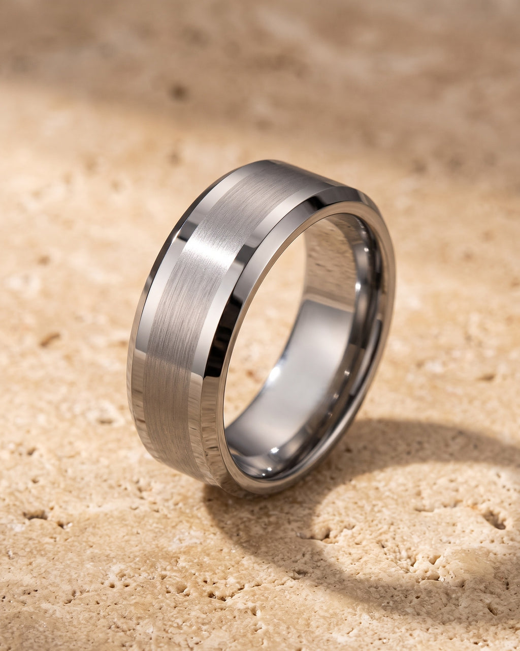 The whole silver-tone Atlas 8 mm matte tungsten carbide band laid on warm stone