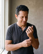 Man in a charcoal henley adjusting his sleeve wearing the silver-tone Atlas 8 mm matte tungsten carbide band