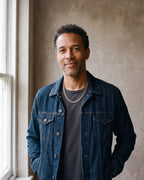 Man in a denim jacket by a window wearing the 9 mm silver Atlas Cuban chain