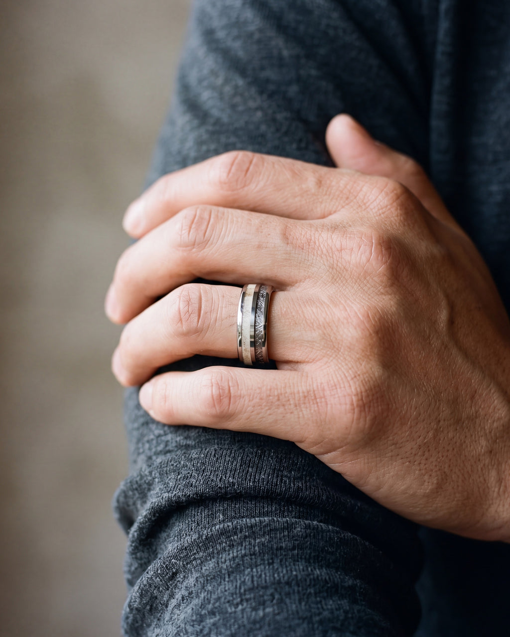 Close-up of the Atlas antler and meteorite inlay ring on a man's hand