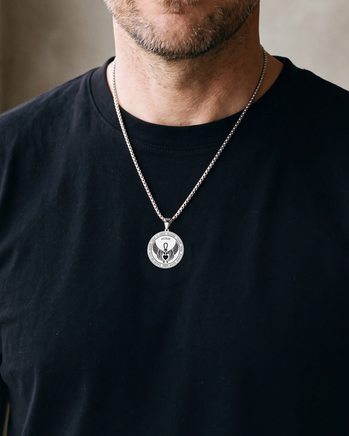 Close-up of the silver-tone Atlas Archangel Michael ankh pendant necklace worn, true size