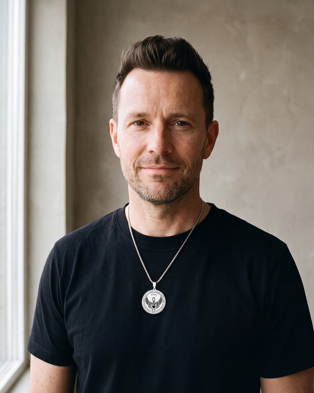 Man in a black T-shirt wearing the silver-tone Atlas Archangel Michael ankh pendant necklace