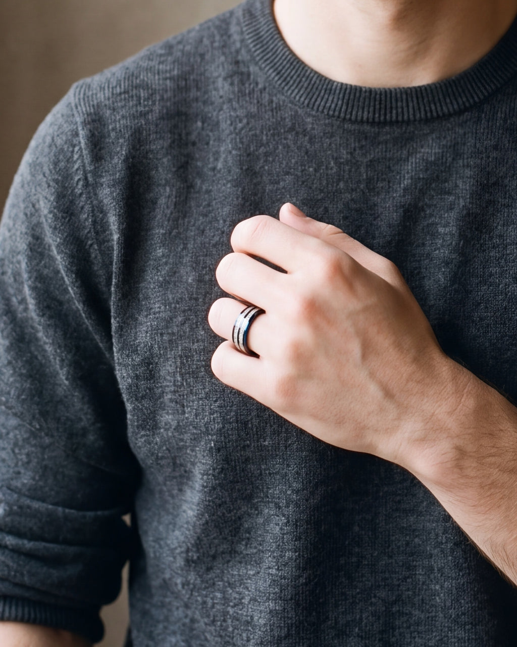 Close-up of a man's hand wearing the Atlas black and blue inlay tungsten ring at true size