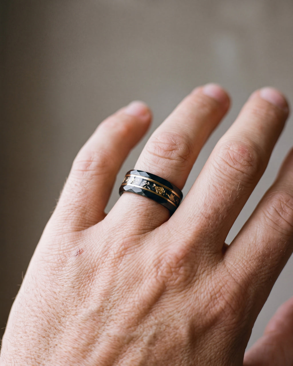 Close-up of the black Atlas black gold-tone flake ring worn at true size