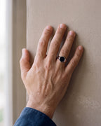 Close-up of a man's hand wearing the Atlas black hexagon signet ring