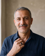 Man in a navy shirt wearing the Atlas black hexagon signet ring