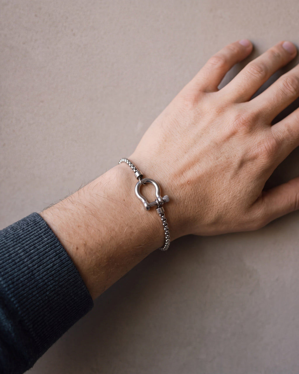 Close-up of the silver-tone Atlas box link shackle bracelet worn at true size