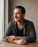 Man in a dark olive overshirt over a black t-shirt wearing the Atlas braided wheat chain in black steel