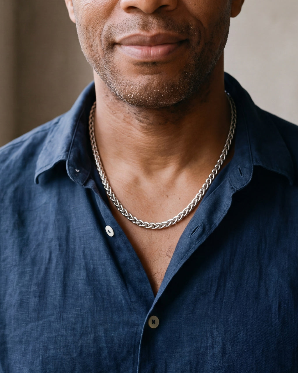 Close-up of the Atlas braided wheat chain in silver-tone steel, worn at true size