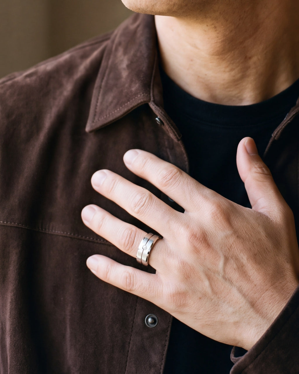 Close-up of a man's hand wearing the Atlas brushed cubic zirconia band ring at true size