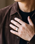 Close-up of a man's hand wearing the Atlas brushed cubic zirconia band ring at true size