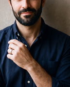 Close-up of the silver-tone Atlas double groove ring on a man's hand