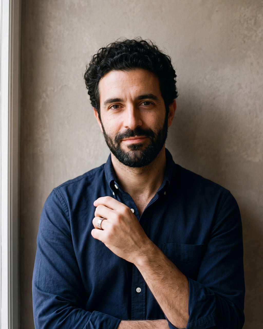 Man in a navy shirt wearing the silver-tone Atlas brushed double groove ring