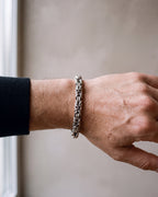 Close-up of the silver Atlas Byzantine link bracelet on a man's wrist