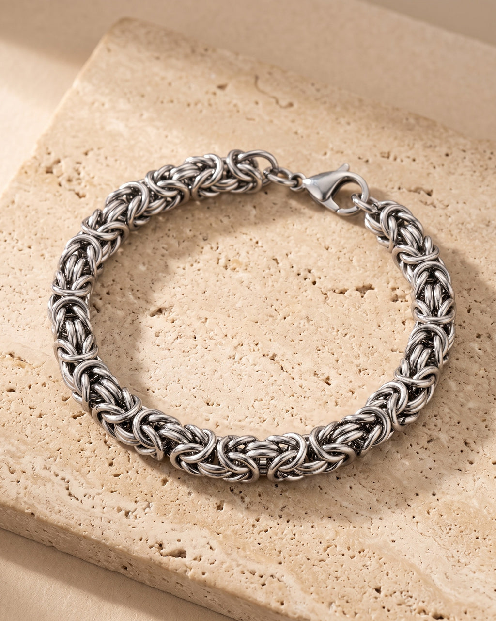 The whole silver Atlas Byzantine link bracelet closed on warm stone