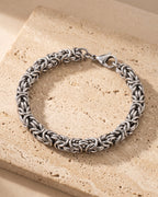 The whole silver Atlas Byzantine link bracelet closed on warm stone