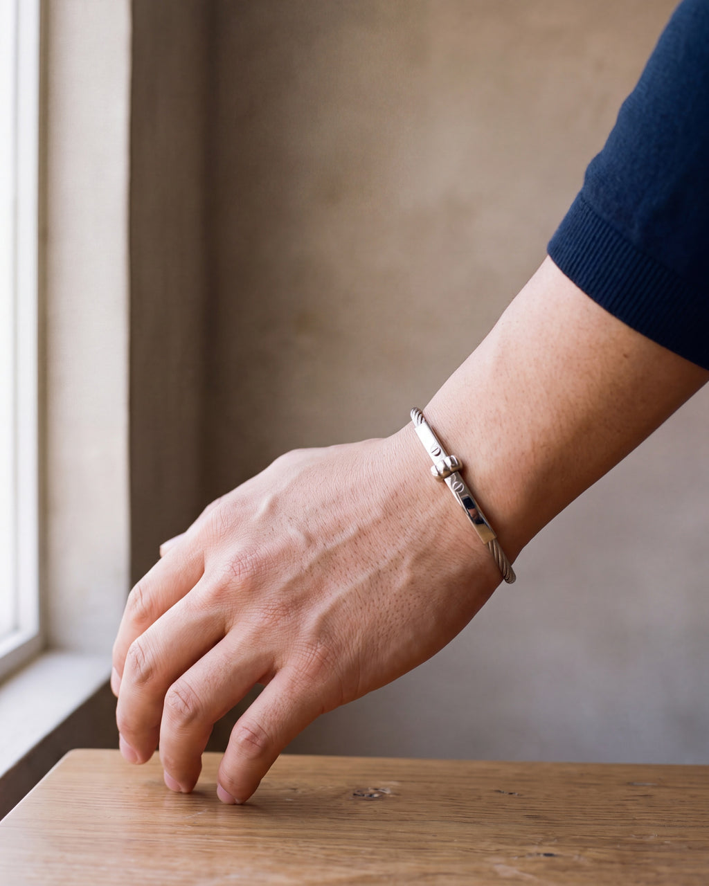 Close-up of the silver Atlas cable bar bracelet worn at true size