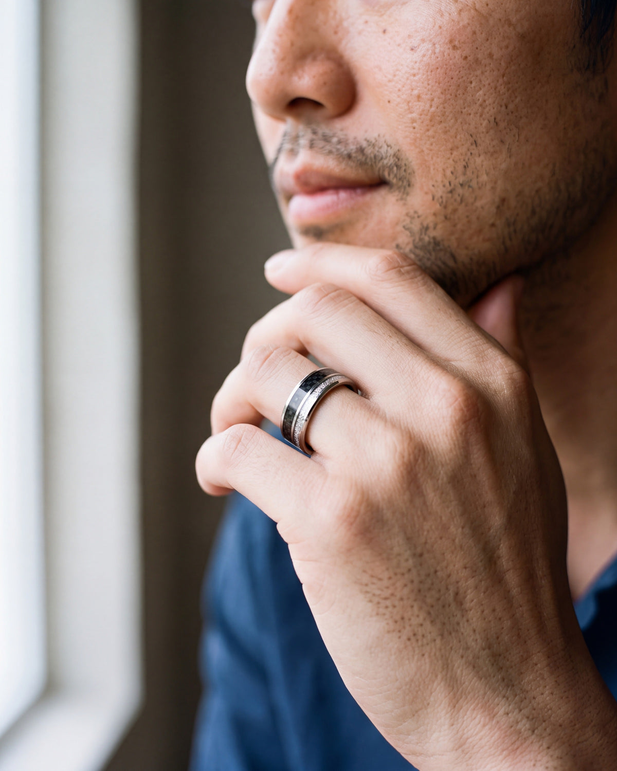 Close-up of the silver-tone Atlas Carbon Fiber Inlay Ring worn at true size