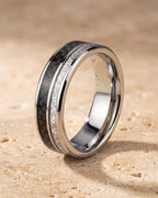 The whole silver-tone Atlas Carbon Fiber Inlay Ring lying on warm travertine stone