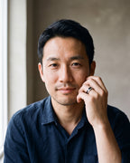 Man in a dark navy linen shirt by a window wearing the silver-tone Atlas Carbon Fiber Inlay Ring