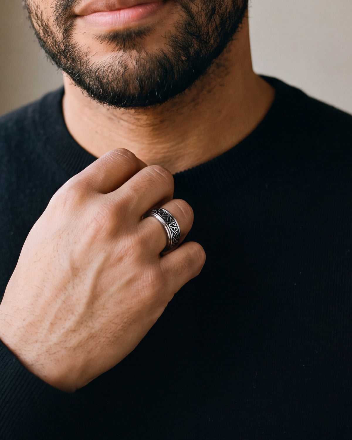 Close-up of a man's hand wearing the 8 mm silver Atlas Celtic knot spinner ring at true size