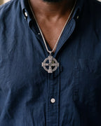 Close-up of the silver-tone Atlas Celtic cross pendant necklace worn, true size