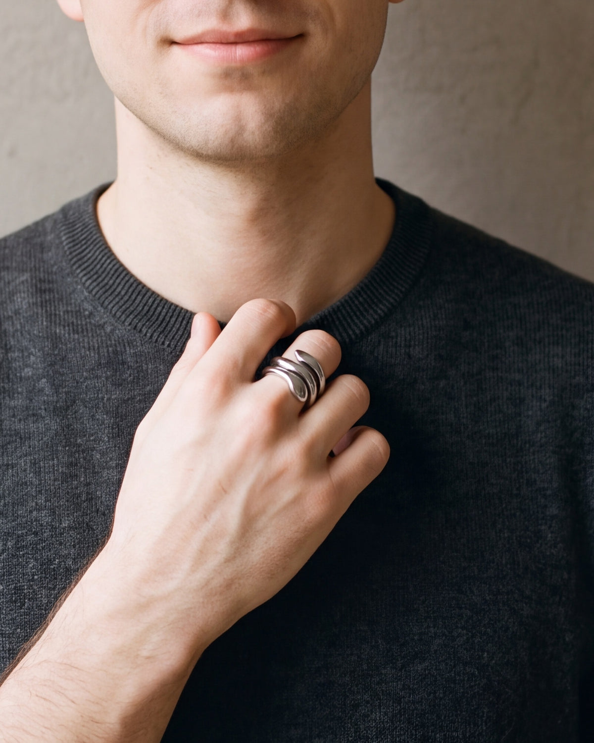Close-up of a man's hand wearing the Atlas coiled snake ring at true size