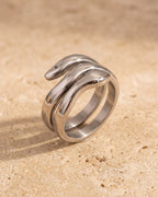 Atlas coiled snake ring standing on warm stone