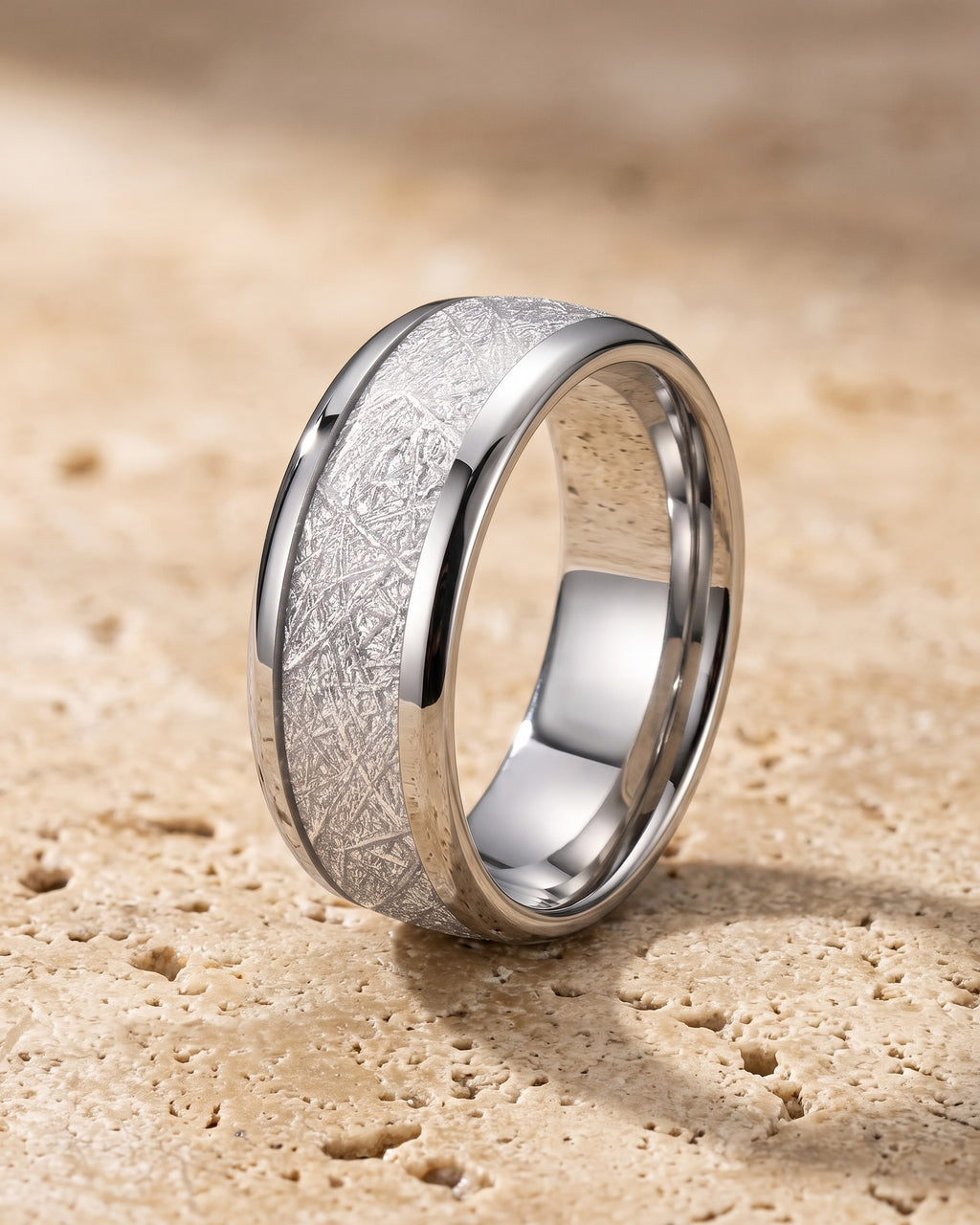 The whole silver-tone Atlas Crosshatch Inlay Dome Ring lying on warm travertine stone