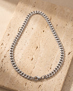 Atlas titanium steel Cuban chain laid whole on warm stone