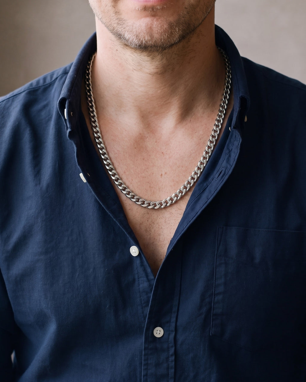 Close-up of the silver Atlas Cuban Link Chain in Stainless Steel worn by a man, shown at true size