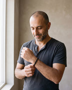 Man in a charcoal henley wearing the Atlas curb link bracelet in black steel
